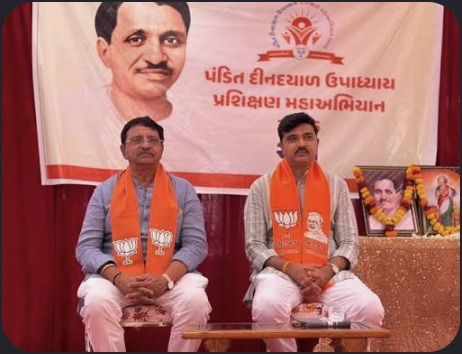 Hardik Tamaliya seated at stage program